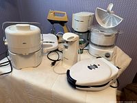 Group shot of all seven small kitchen appliances on table