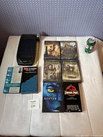 All items laid out including DVDs, VHS tapes, rewinder, cleaner cassettes