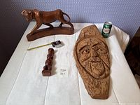 Group shot showing all three wooden carvings with size references