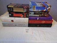 Stack of nine Diana Gabaldon novels showing spines and dust jackets