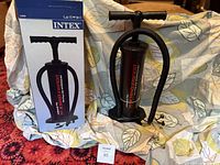 Pump standing beside box on patterned fabric background