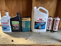 Various liquid containers lined up on shelf