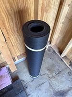 Full view of tar paper roll standing upright