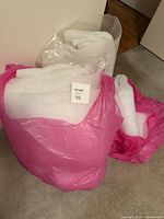 Three bags containing white quilt batting
