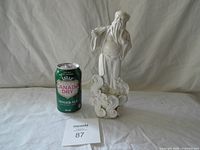 Front view of white porcelain Zhongli Quan statue beside can for scale