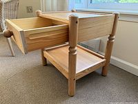 Side view showing drawer extended, lower shelf, turned legs