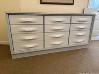 Front view of white 9-drawer dresser