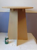 Full view of round particle board table with soda can for scale