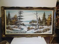 Full view of framed winter landscape painting