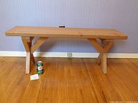 Full view of solid pine bench showing top, legs and size reference can