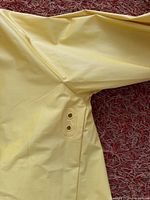 Underarm showing two ventilation eyelets and yellow PVC fabric