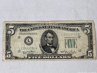 Front view of the 1950 series $5 Federal Reserve Note showing Abraham Lincoln portrait and serial numbers.