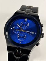 Front view of Fossil Arkitekt wristwatch showing dark blue dial, subdials, and date window.