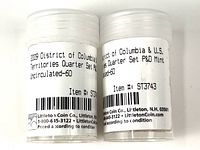 Two white capped plastic tubes with labels indicating 2009 District of Columbia Territories Quarter Set Proof and Uncirculated rolls from Littleton Coin Co.