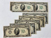 Seven $10 notes fanned, front and back visible