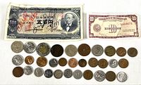 Full lot showing the signed 500 Yen Japanese banknote, Philippine 10 Peso banknote, and assorted coins including silver, bronze, and bi-metal types arranged in rows.
