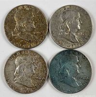Obverse sides showing Franklin's profile on each coin, with visible dates 1958, 1961, 1962, 1963 and signs of tarnish.