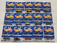 Front view of fifteen Mattel Hot Wheels 2000 First Editions die cast cars in original sealed packaging, arranged in three rows on a white surface.