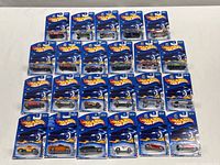 Overview photo showing all 23 Hot Wheels die cast cars still sealed in original Highway 35 - 35th Anniversary blue packaging, laid out in rows.