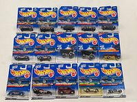 All 15 Hot Wheels cars sealed in blister packs laid out in a grid showing card backing with blue Hot Wheels logo and product info.