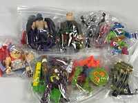All seven Teenage Mutant Ninja Turtles 4-inch figures in sealed plastic bags with accessories grouped together