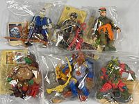 Overview of six 4-inch Teenage Mutant Ninja Turtle figures with accessories in individual bags.