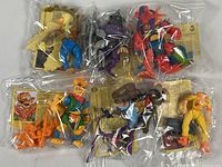 Photo of all six sealed TMNT action figures, each with accessories and info cards visible inside plastic bags.