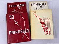 Four Fremont HS Pathfinder yearbooks from 1957 through 1960 displayed together, showing covers and condition.