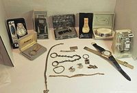 Overview of all watches, bracelets, keychains, jewelry items arranged on white background