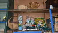 Wide photo of multiple Easter and Christmas decor items on a shelf including baskets, duck light, bendable rabbits and Christmas lights