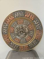 Full view of round brass wall plate showing overall design and size perspective