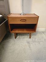 Full view of Dyrlund teak nightstand showing drawer, shelf, legs