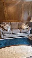 Front view of sofa showing overall condition and pillows