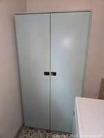 Closed front view of metal cupboard