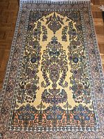 Full view of silk oriental rug showing overall design and condition