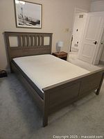 Full view of assembled Ikea Hemnes queen bed frame with mattress