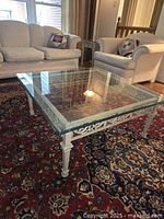 Overall view of square glass coffee table in living room