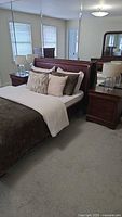 Queen sleigh bed with nightstand and dresser visible