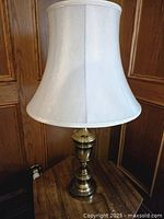 Full view of lamp displaying shade and brass base