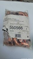 Bag of 50 copper pressure fittings labeled 1/2 inch 90 degree elbows showing product code and quantity.