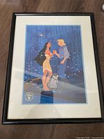 Front view of the framed Disney Pocahontas lithograph print showing the artwork of Pocahontas and John Smith with the raccoon in a forest background.