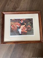 Front view of the framed and matted print showing Snow White and several dwarfs in a colorful indoor scene.