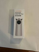 Front box showing the product image and name: Rojeco Automatic Laser Pet Toys with English and Chinese text.