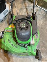 Top front angled view of the green Lawn Boy Silver Series lawn mower showing engine cover, fuel tank, and part of the deck with Easy Mulch label.