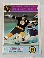 Front of the vintage 1974-75 OPC hockey card showing Bobby Orr in Bruins uniform skating on ice, labeled as First Team All-Stars.