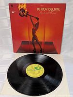 Vinyl record LP shown with black disc and yellow label on white inner sleeve, condition of vinyl visible and very good.