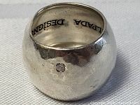 Front view of the sterling silver hammered ring with a small diamond set in the band. Shows the texture and diamond placement.