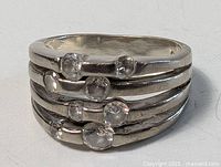 Front angle view of sterling silver multi-band ring with five stones showing the arrangement and bands.