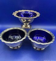 All three footed bowls showing cobalt liners and differing rim designs