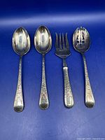 Four Birks silverplate serving pieces displayed to show variety